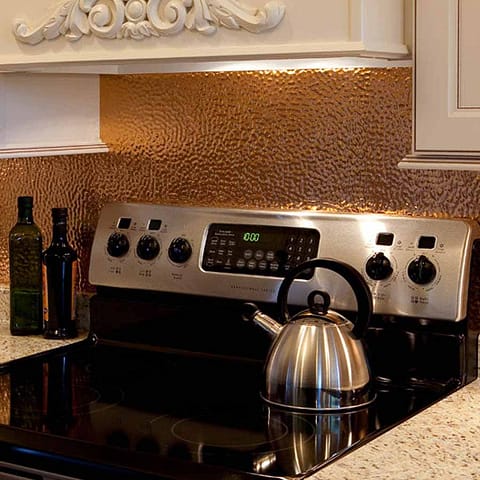 Fasade Backsplash - Hammered in Polished Copper