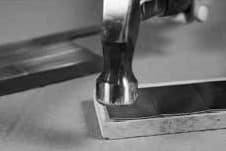 Use a hammer to straighten tile edges.