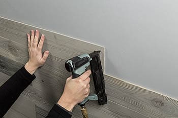 Nail planks to wall