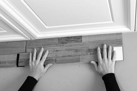 Beginning from inside corner on left, place the first tile