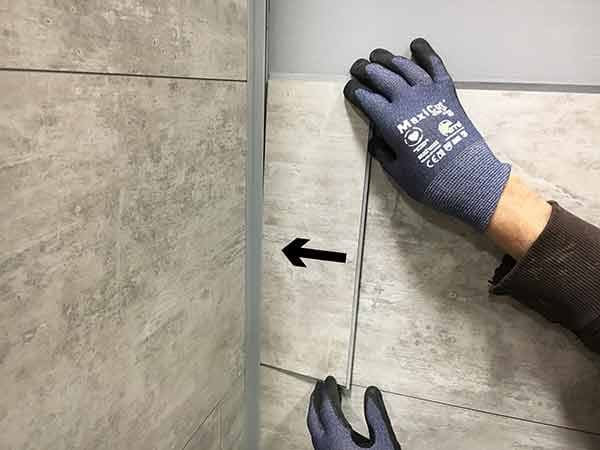 Insert cut edge into edge trim channel while holding other edge up